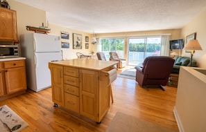 Enjoy meals and relaxation in this well-equipped kitchen and dining area with a comfortable seating space.