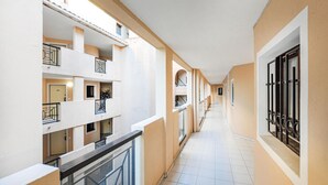 A corridor with multiple balconies, a staircase, and a door with a window. - 1 bedroom beautiful apartment in Cannes (Cannes)