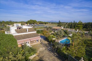 A large property with a swimming pool, a covered patio, and a view of the surrounding landscape. - Spacious 5-bedroom Villa with pool and barbecue (Can Picafort)