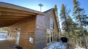 A wooden cabin with a deck, large windows, and a covered porch area. - Pool-Table Game Room, Darts & Starlink - Pet-Friendly, Mtn Views (Fairplay)