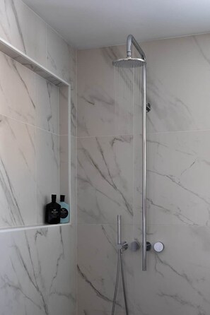 A shower with a handheld showerhead, a handheld shower attachment, and a handheld shower hose. - Sea Notes Beach House Yamba (Yamba)
