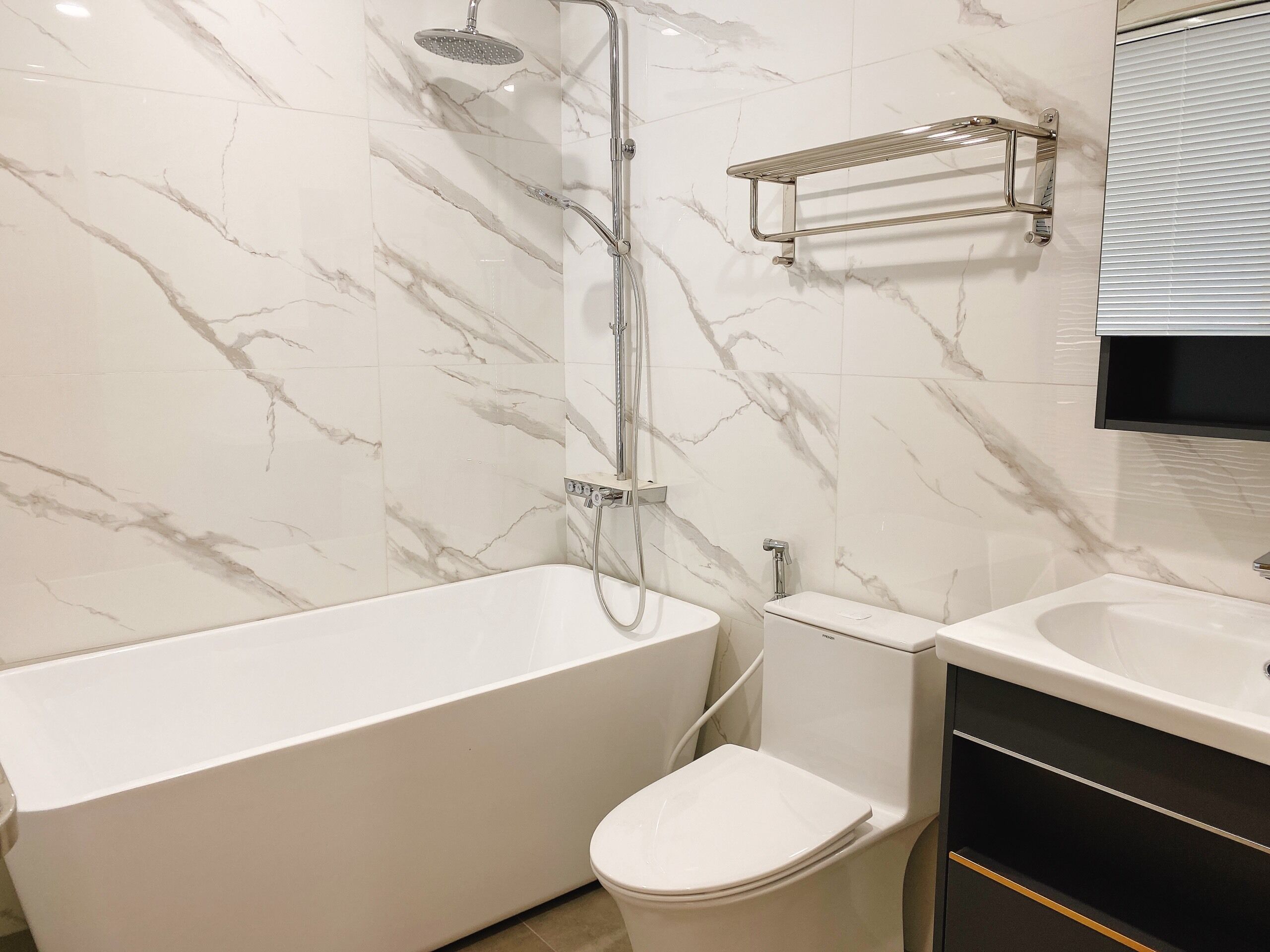 A bathroom with a bathtub, toilet, and a shower.