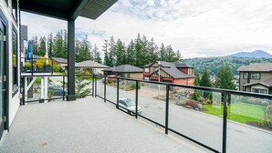 A balcony with a view of a residential area, including houses and a mountain in the background. - Gorgeous house on the top of the mountain in Chilliwack (Chilliwack)