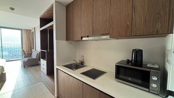 A modern kitchen with wooden cabinets, a built-in microwave, and a sink.
