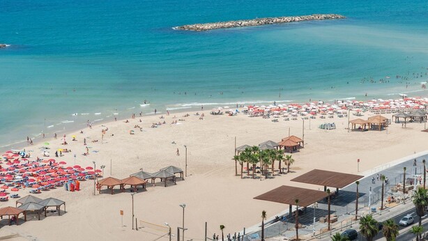 A beach with umbrellas and beach huts. - Sunny 4 BR Apt in the seaside of Achziv (Nahariya)