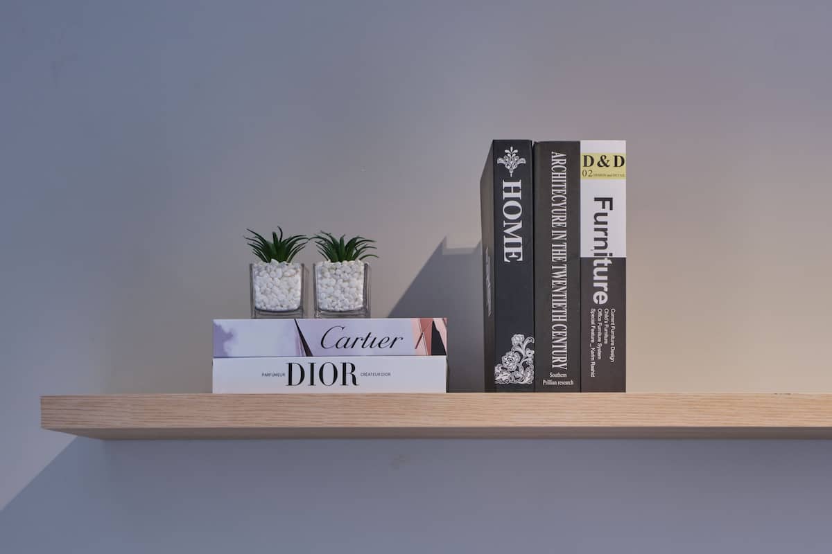 A shelf with books and decorative items.