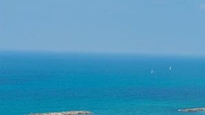 A coastal view with clear blue sea and rocky shoreline. - Authentic Beachfront Apartment (Nahariya)