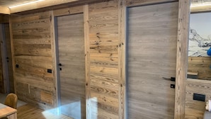 Une rangée de portes en bois au design moderne, qui donnent probablement accès à des chambres privées ou à des suites.