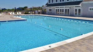 A swimming pool adjacent to a building with a large windowed porch. - D124- Classic Duck Oceanfront - 4 Brs Outstanding Ocean Views & Comm. Pool (Duck)
