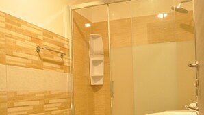 A bathroom with a glass-enclosed shower, a bidet, and a sink. - Napoleone Luxury Home (Rome)