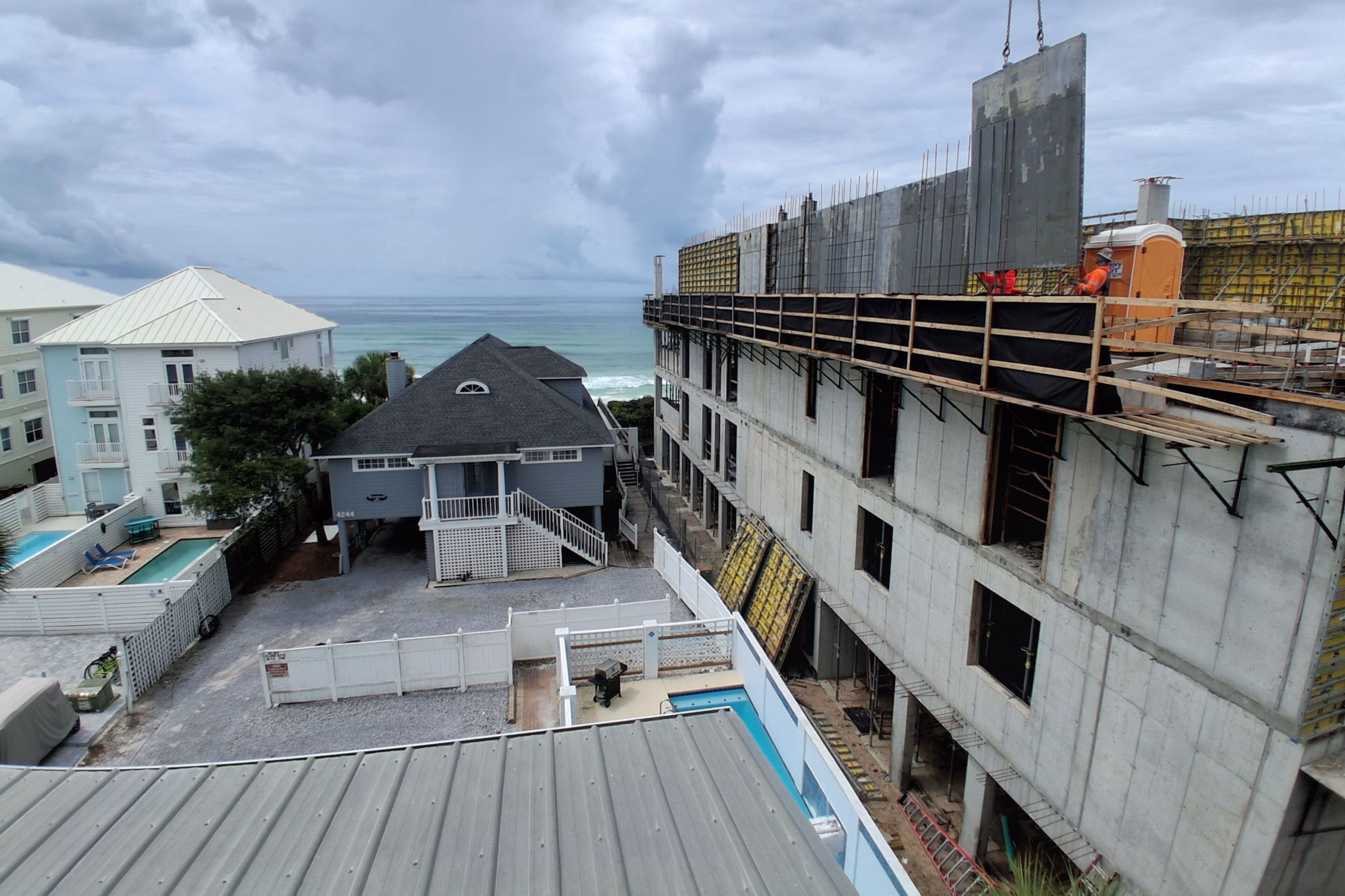 A building under construction with a view of the ocean.