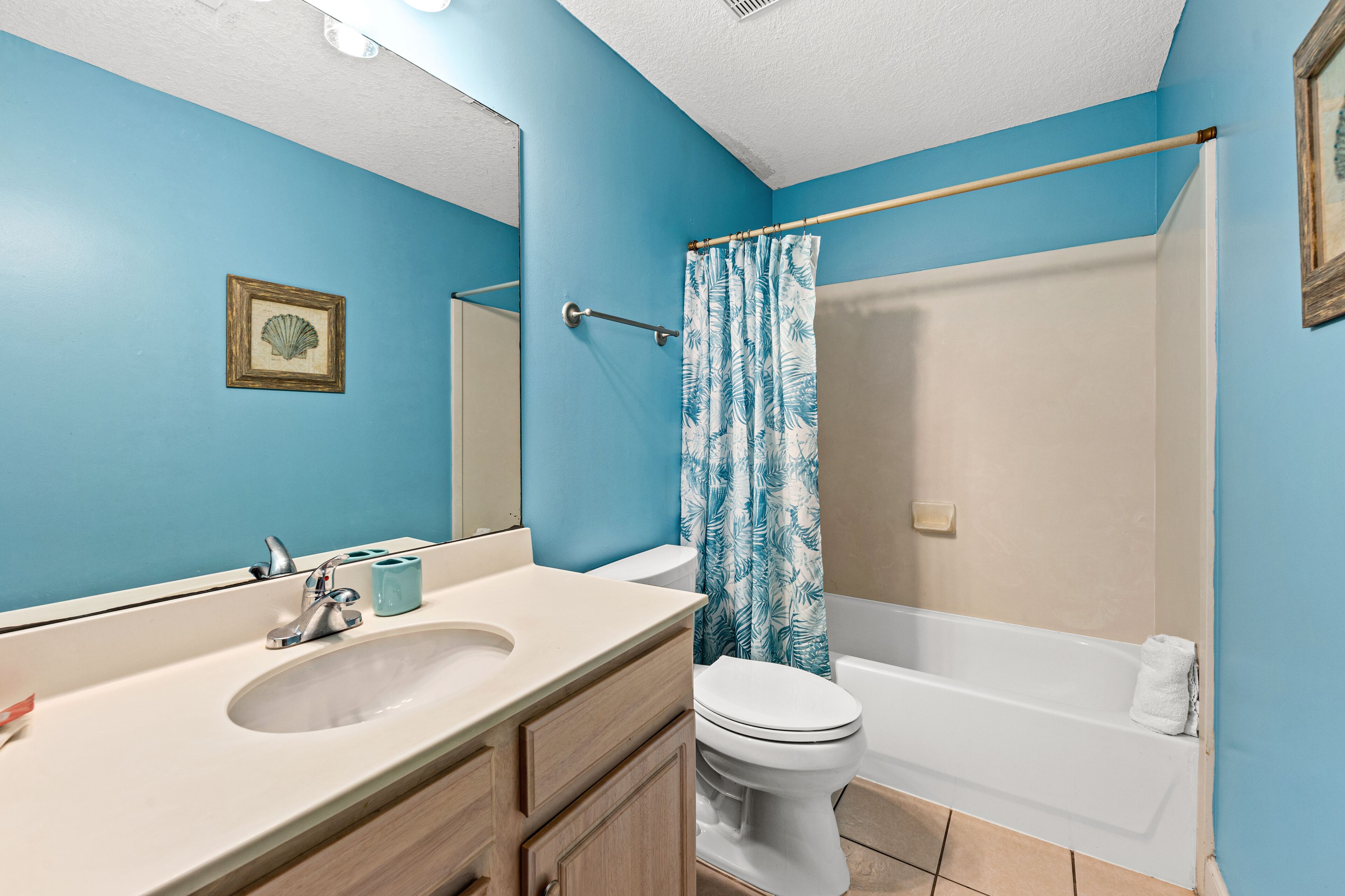A bathroom with a sink, toilet, and bathtub.