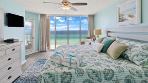 A bedroom with a large bed, a ceiling fan, a TV, and a view of the ocean. - The Perfect Escape! Long Beach Resort-8th Floor-gulf Front With Amazing Views (Panama City Beach)