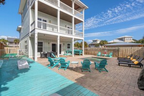 A multi-story house with a covered patio, outdoor seating, and a swimming pool. - Three Master Bedrooms! Easy Beach Access! Gulf Views (Panama City Beach)