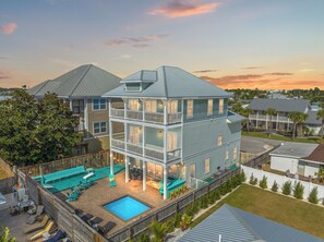 A multi-story house with a pool, outdoor seating, and a fenced backyard. - Three Master Bedrooms! Easy Beach Access! Gulf Views (Panama City Beach)