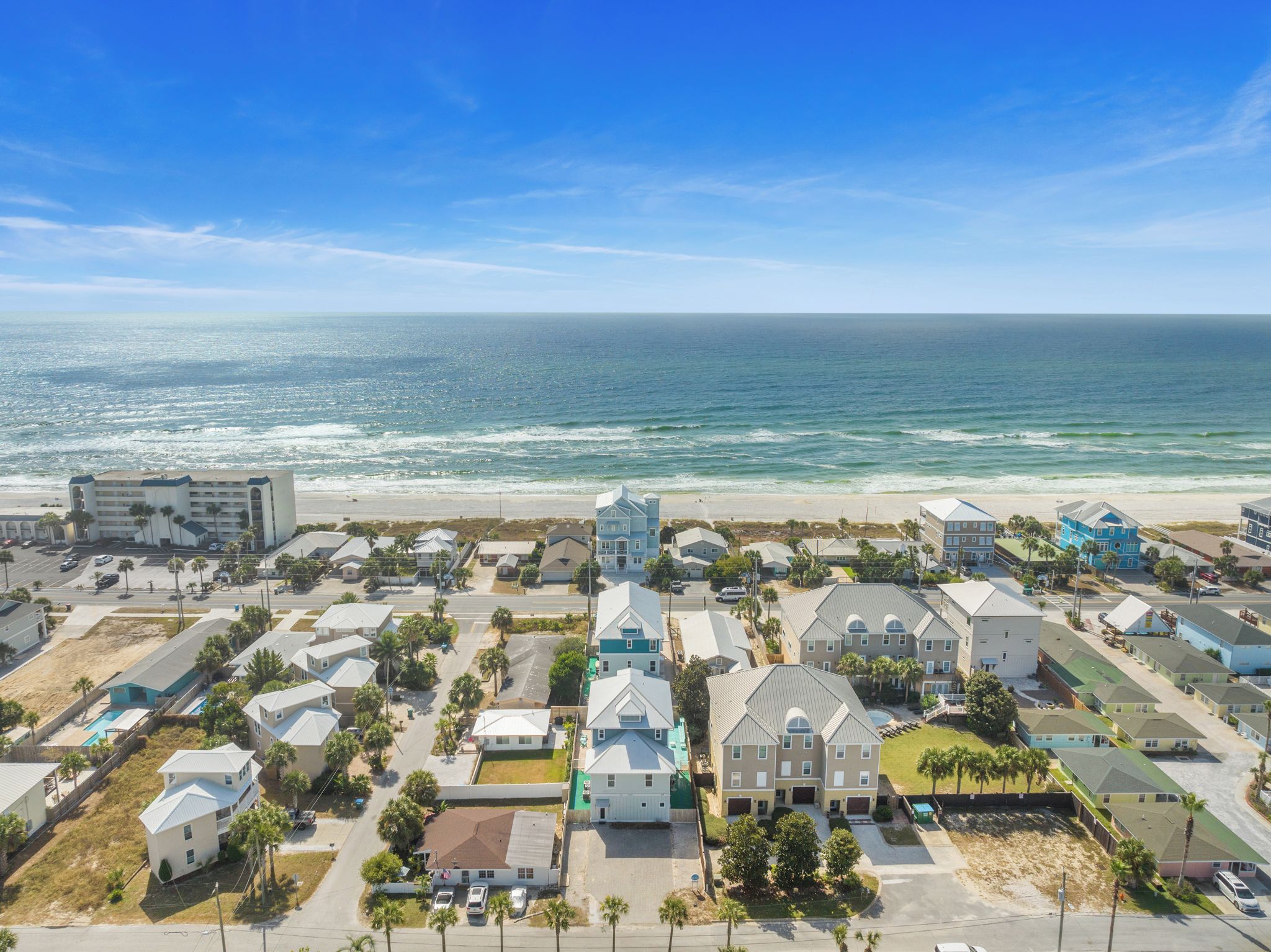 A coastal residential area with a beachfront hotel and townhouses.