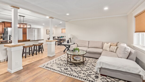 A spacious living area with a sofa, coffee table, and a patterned rug.