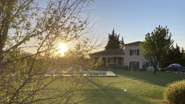 A house with a well-maintained lawn and a patio area.