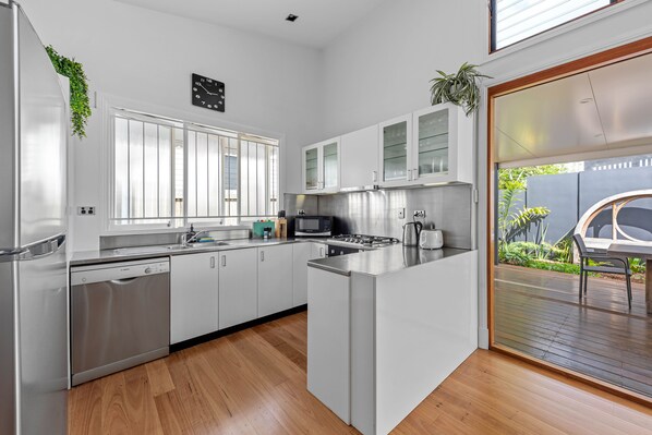 Enjoy cooking in this well-lit kitchen with a dishwasher, microwave, and gas stove.