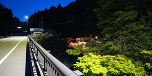 Surrounded by dense forest, this property offers a serene escape along a well-lit highway.