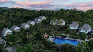 A resort with dome-shaped cottages, a swimming pool, and lush greenery. - The Kleep Jungle Resort (Penida Island)