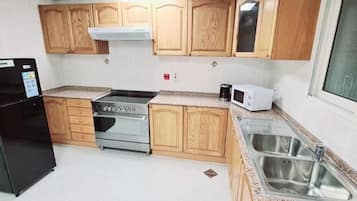 Apartment | Private kitchen | Full-size fridge, microwave, oven, cookware/dishes/utensils