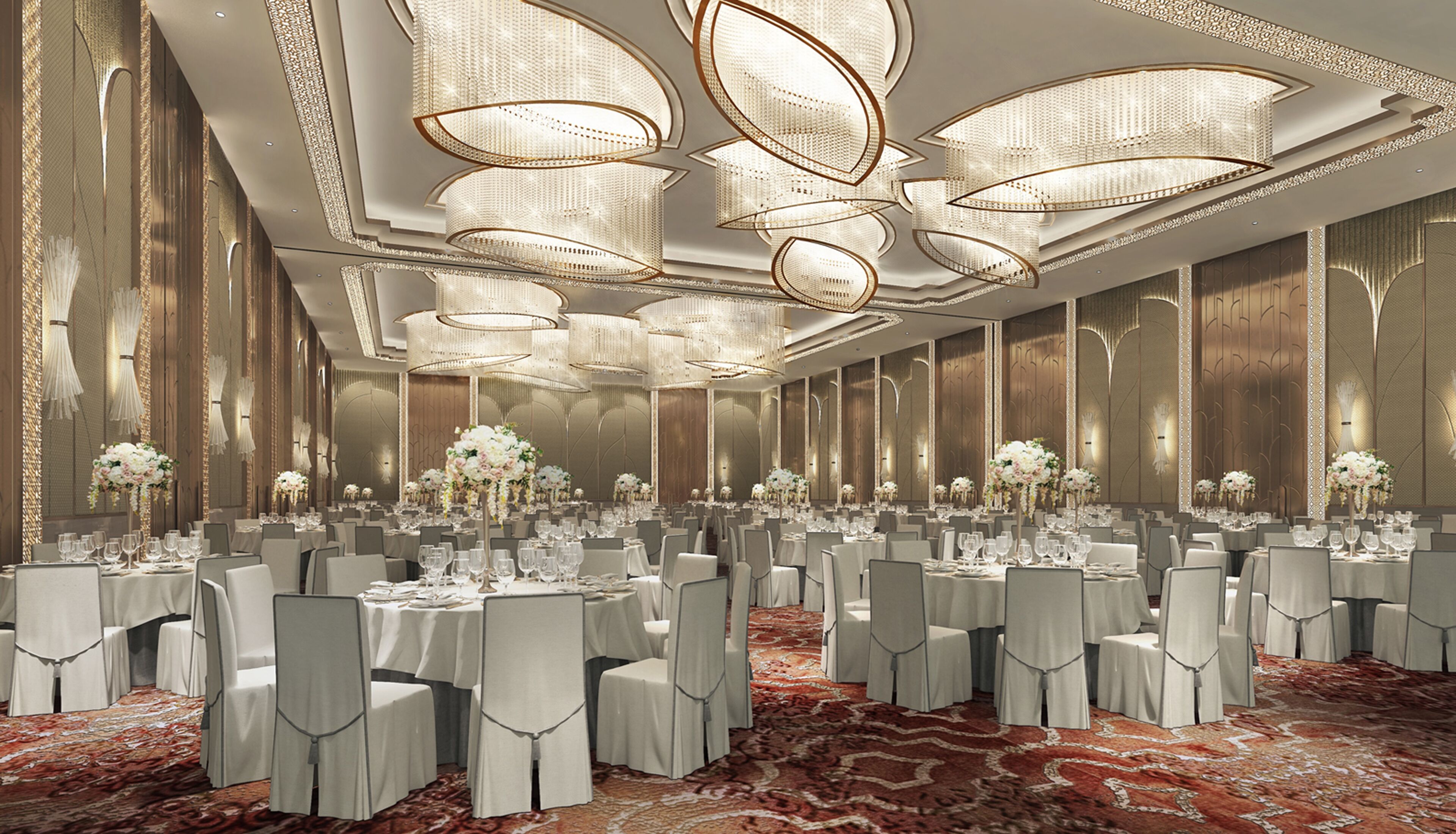 A banquet hall with round tables, white chairs, and floral centerpieces.