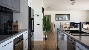 Oven, dishwasher, coffee/tea maker, dining tables