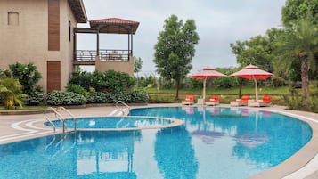 Outdoor pool, pool umbrellas, lifeguards on site