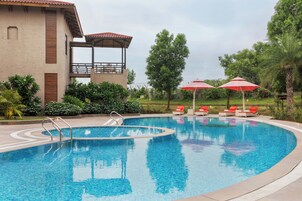 Outdoor pool, pool umbrellas, lifeguards on site