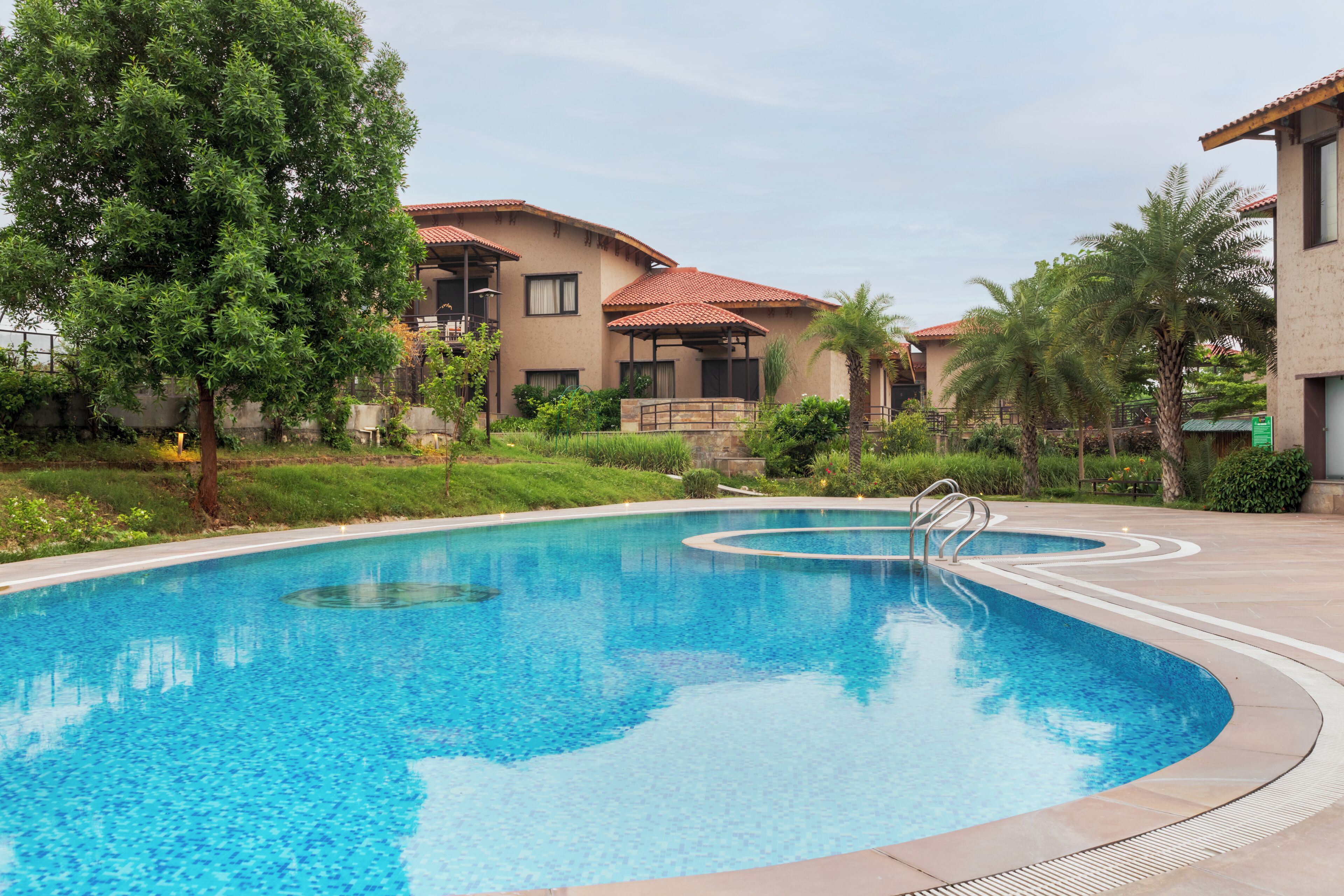 Outdoor pool, pool umbrellas, lifeguards on site