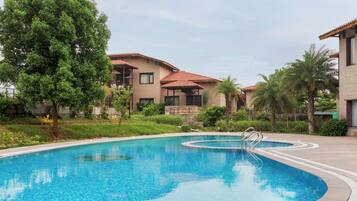 Outdoor pool, pool umbrellas, lifeguards on site