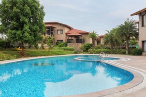 Outdoor pool, pool umbrellas, lifeguards on site