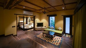 A room with a wooden ceiling, a bed, a TV, a bench, and a window with a view. - Aamaghati Wildlife Resort (Sawai Madhopur)