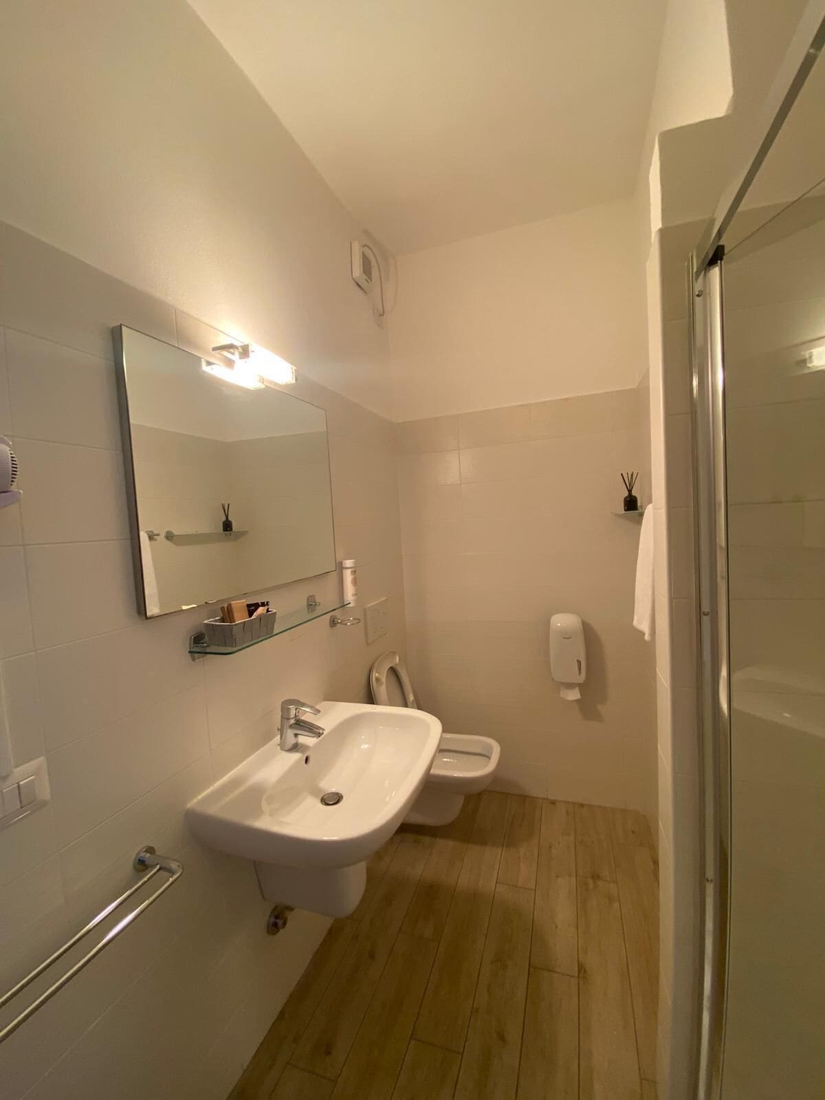 A bathroom with a sink, toilet, and shower.