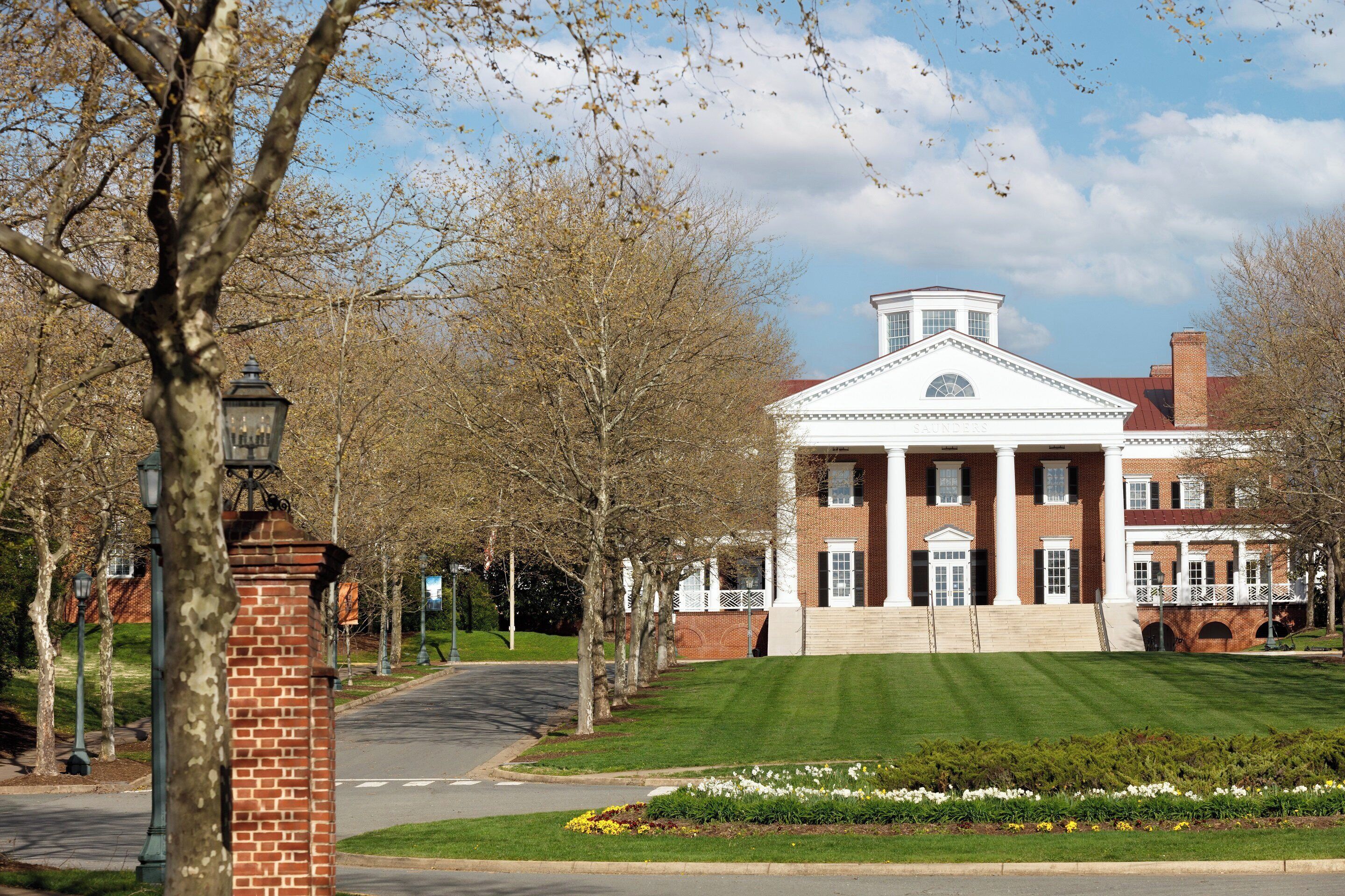 A large, historic building with a symmetrical facade, columns, and a central pediment.
