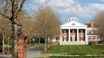 A large, historic building with a symmetrical facade, columns, and a central pediment.