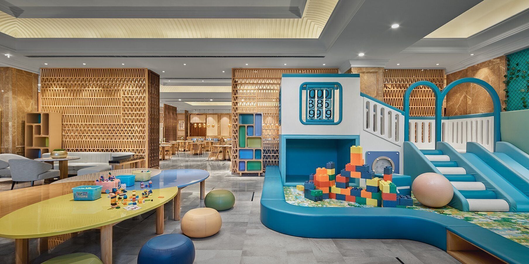 A children's play area with a slide, play structures, and seating.