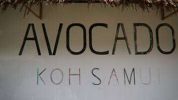 A sign with the word "AVOCADO" and "KOHSAMUI" written on it.