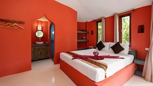 A room with a large bed, a vanity with a mirror, and a window with curtains. - Avocado (Koh Samui)