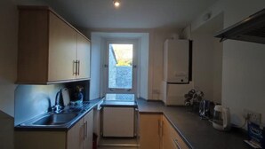A compact kitchen with a window, a refrigerator, and a sink. - Kirkcaldy, Fife • Lovely 2 Bedroom Flat • Sea View (Kirkcaldy)