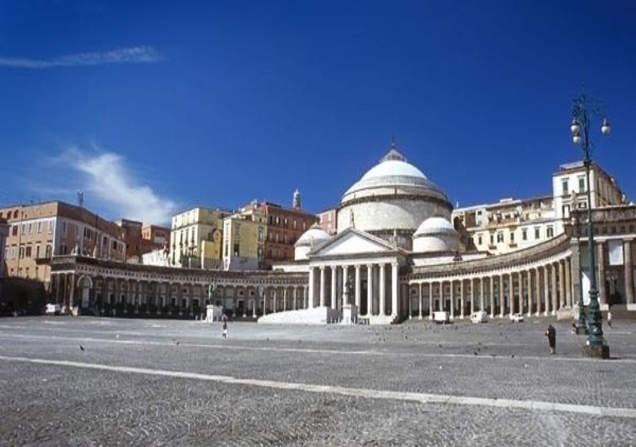 A large open plaza with classical architecture, including a prominent dome and columns, surrounded by buildings.
