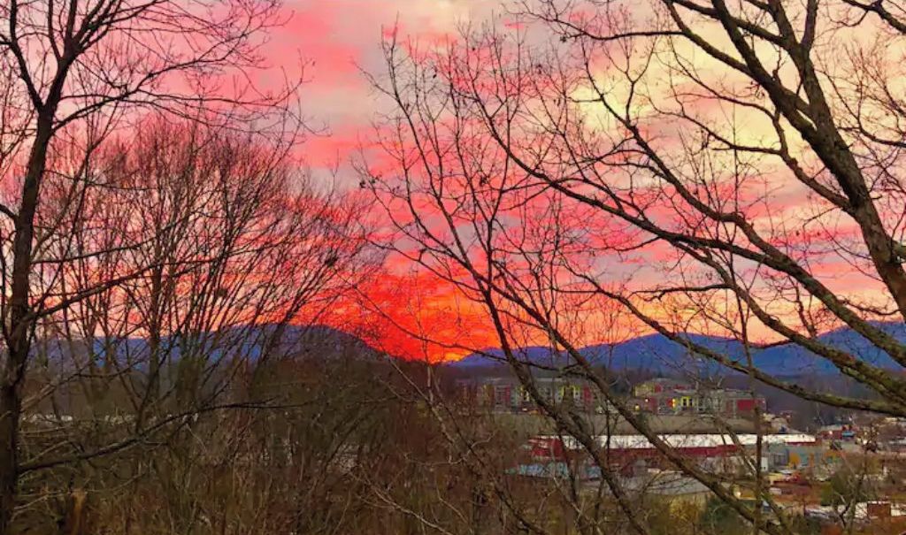 A landscape with mountains and a sunset.