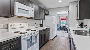 2 Queen Beds, 1-Bedroom Suite, Living Room, Non-Smoking | Desk, laptop workspace, blackout drapes, iron/ironing board
