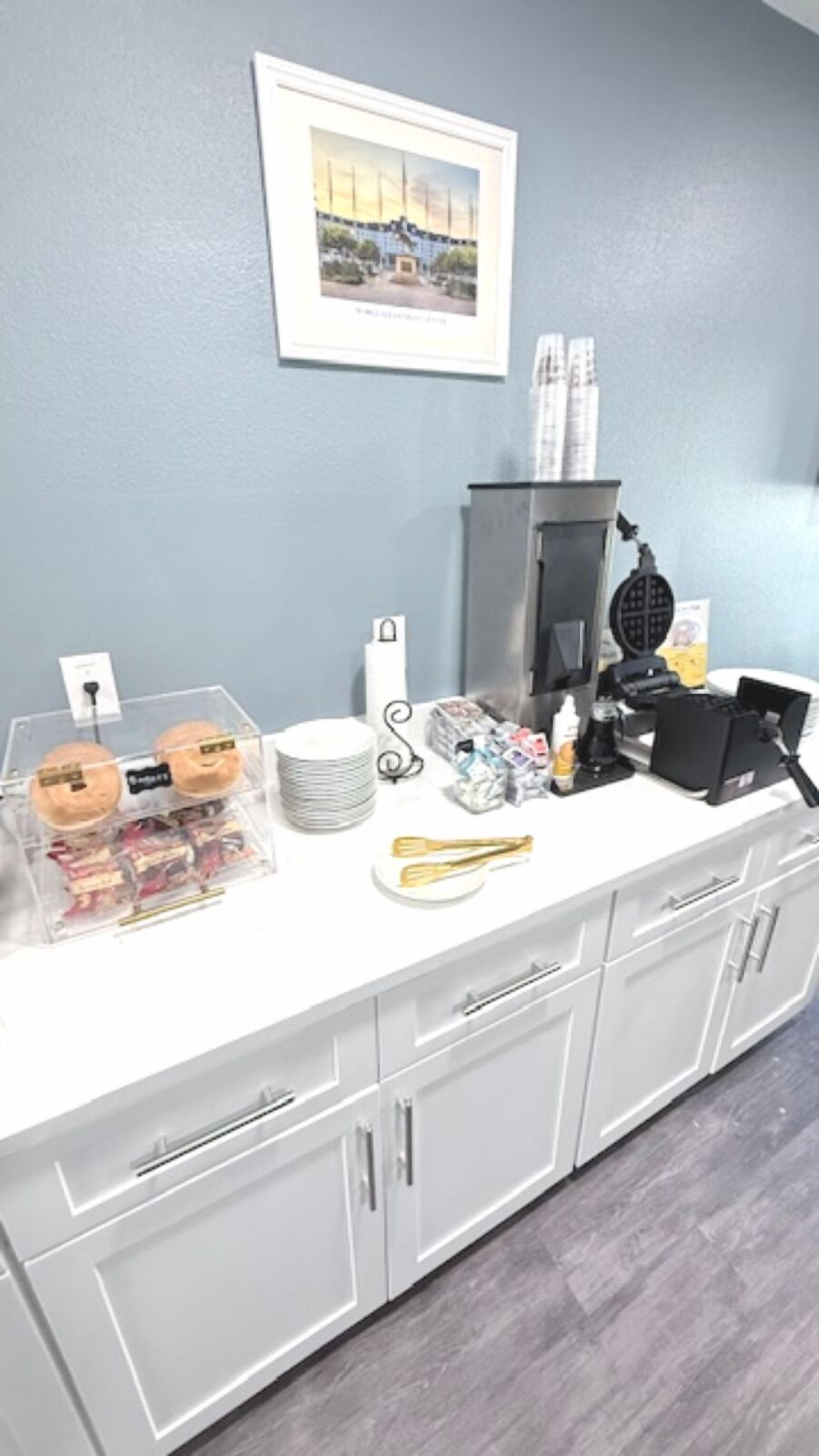 A kitchen counter with a coffee machine, a kettle, and various kitchen utensils.