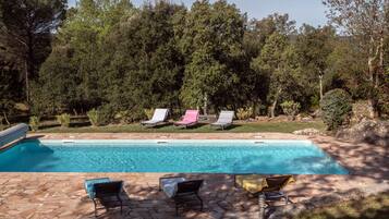 A heated pool, sun loungers