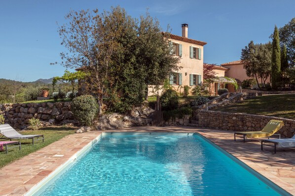 A heated pool, sun loungers