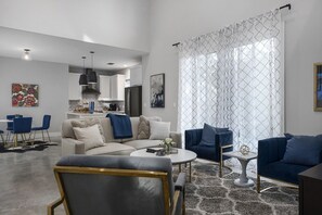 Relax in a spacious living area with a sofa, armchairs, and a coffee table.