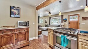 A kitchen with wooden cabinets, a microwave, and a stove. - Dancing Bear Cabin Pet Friendly, Sleeps 4, Totally Cute! (South Lake Tahoe)