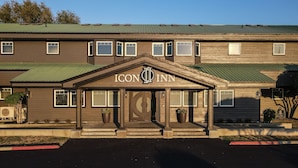 A hotel with a prominent entrance featuring a large sign reading "ICON INN". - Icon Inn (Ellensburg)